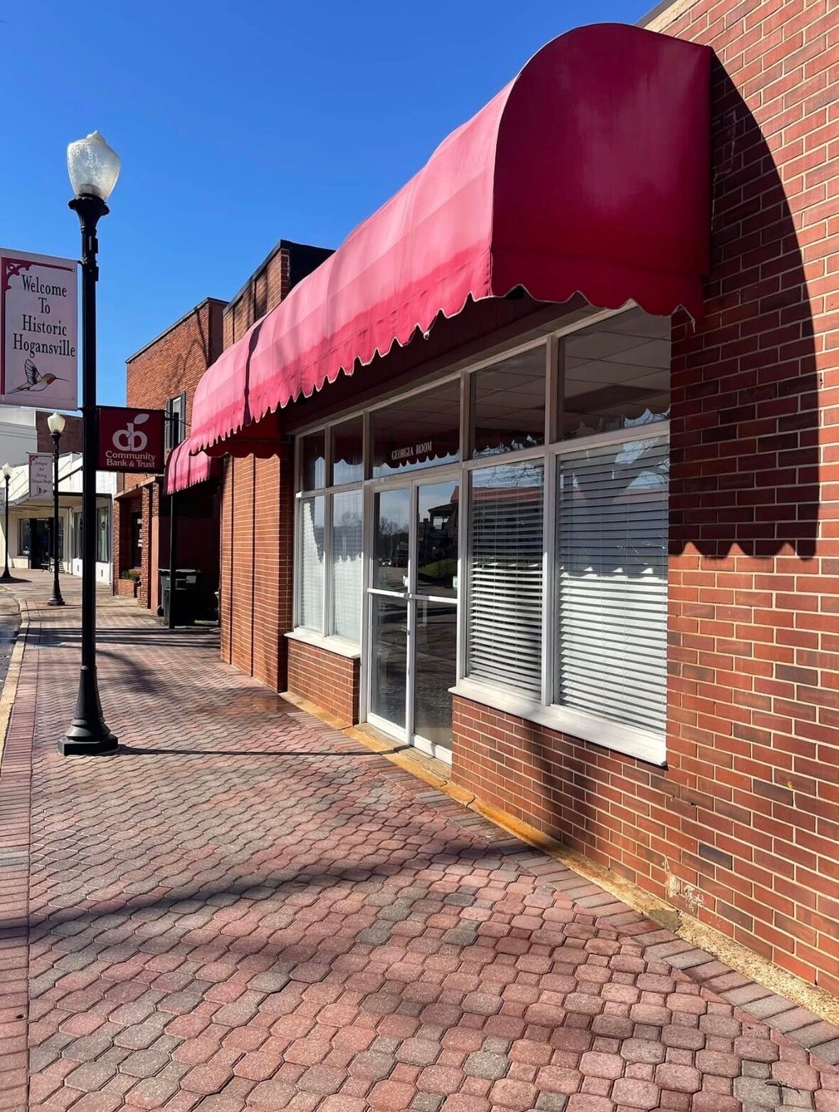 Historic Hogansville Georgia brick storefront and sidewalk after exterior cleaning
